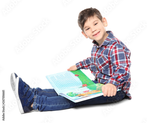 Cute little boy reading boo...