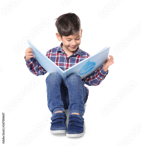 Cute little boy reading boo...