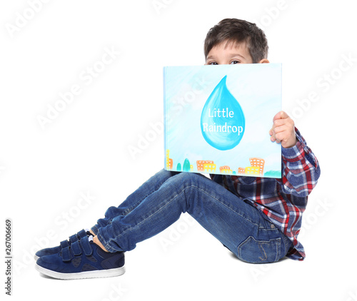 Cute little boy with book o...