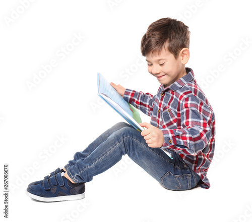 Cute little boy reading boo...
