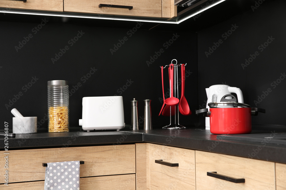 Kitchen interior with new furniture, appliances and houseware Kitchen interior with new furniture, appliances and houseware