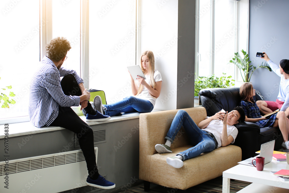 Students resting together in campus building Students resting together in campus building