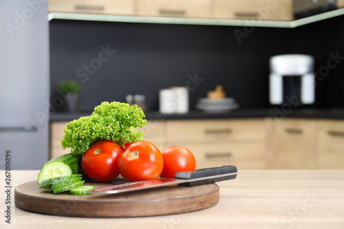 Fresh vegetables on wooden table in kitchen. Space for text