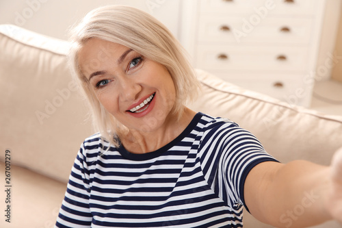 Mature woman using video chat at home, view from web camera