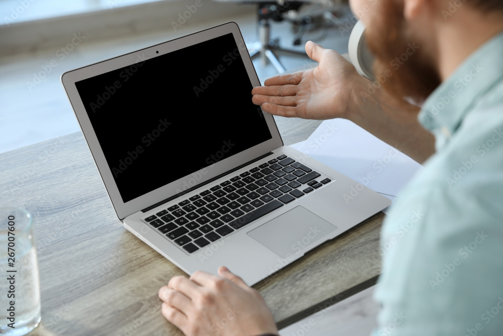 Man using video chat on laptop in home office, closeup. Space for text Man using video chat on laptop in home office, closeup. Space for text