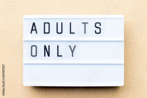 Fotografi White lightbox with word adults only on wood background