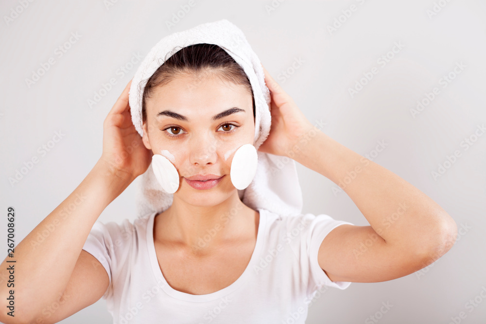 Beautiful brunette woman removing makeup from her face Beautiful brunette woman removing makeup from her face