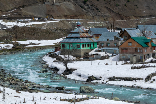 Beautiful small village riverside with snow in winter during trip to Sonamarg is attractions in Kashmir, India photo