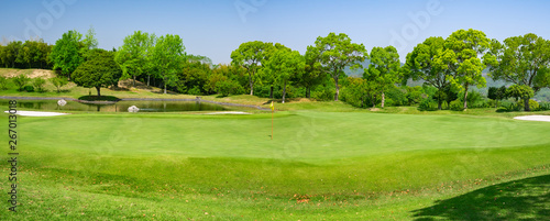 Fototapeta Naklejka Na Ścianę i Meble -  Panorama View of Golf Course with beautiful green. Golf is a sport to play on the turf.	