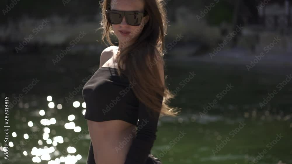 Closeup portrait of a beautiful young woman on a windy beach in bikini Closeup portrait of a beautiful young woman on a windy beach in bikini