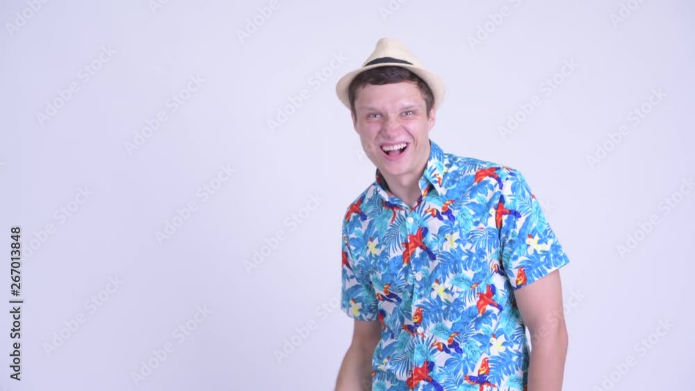 Happy young tourist man touching something and looking surprised Happy young tourist man touching something and looking surprised