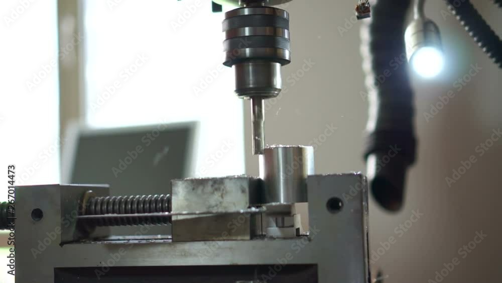 Milling machine smooths surfaces on aluminum cylinder.Setting up and milling a metal cylinder on a drilling machine. Milling machine smooths surfaces on aluminum cylinder.Setting up and milling a metal cylinder on a drilling machine.