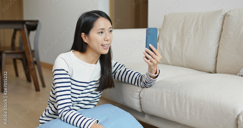 Woman having video call on cellphone at home Woman having video call on cellphone at home