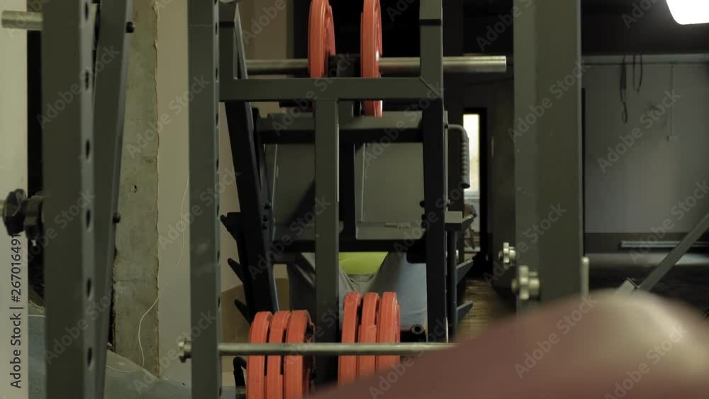 A man with excess weight doing leg presses on the simulator in the gym. Fitness training. Healthy lifestyle concept A man with excess weight doing leg presses on the simulator in the gym. Fitness training. Healthy lifestyle concept