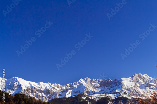 snow covered mountain peaks under blue sky © Kirill