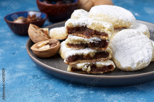 Arabic homemade cookies filled with dates and walnuts covered powdered sugar