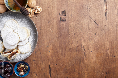 Arabic homemade cookies filled with dates and walnuts covered powdered sugar photo