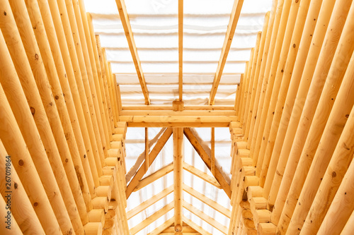 construction of eco-friendly house made of wood. walls and ceiling of the unfinished house from the log. the concept of building a natural eco-friendly house and eco-friendly building material