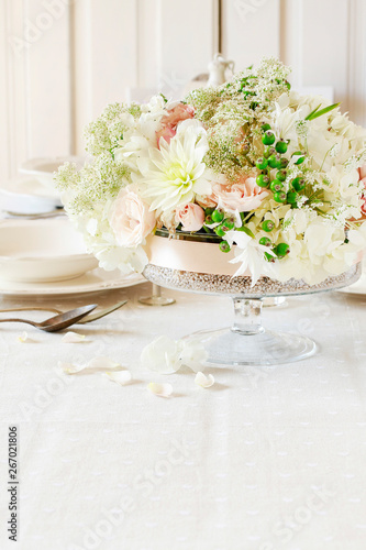 Floral decorations on summer party table   romantic wedding reception.