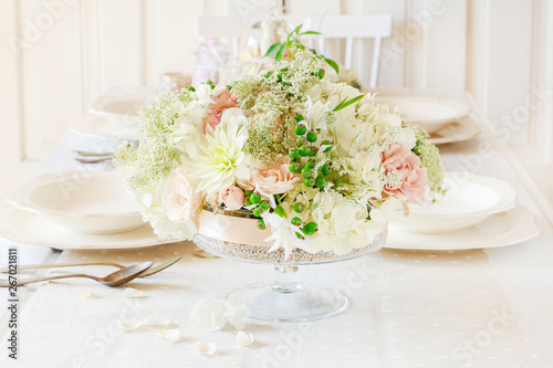 Fototapeta Naklejka Na Ścianę i Meble -  Floral decorations on summer party table,  romantic wedding reception.