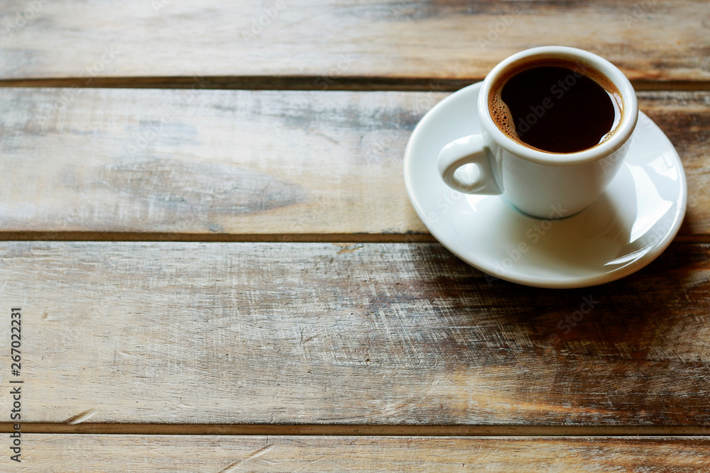 Cup of coffee on brown wooden table Cup of coffee on brown wooden table
