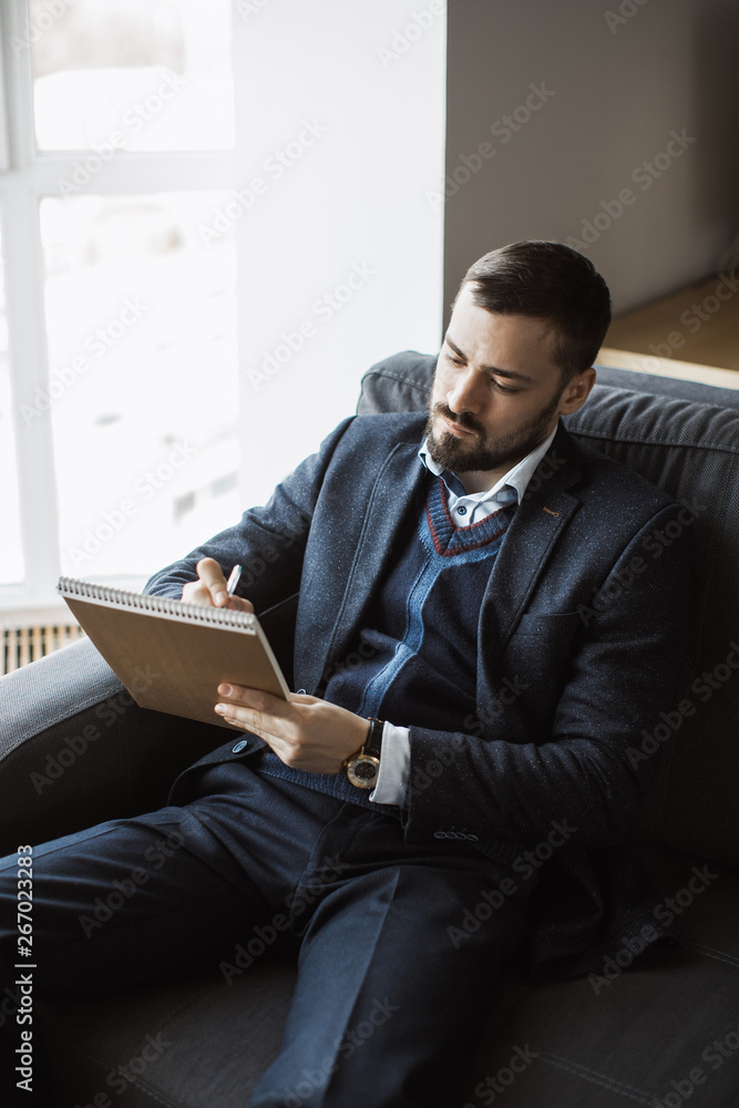 Man Working In Office Doing Notes Man Working In Office Doing Notes
