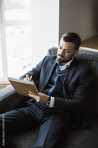 Man Working In Office Doing Notes