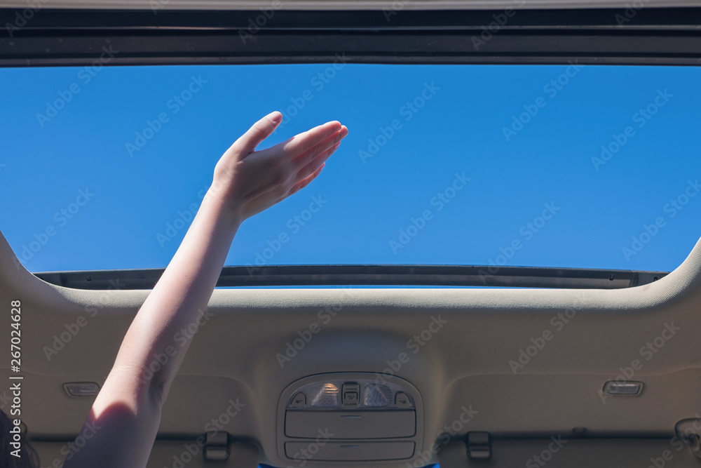 girl driver traveling by car and holds her hand out from open hatch of a vehicle. Travel lifestyle concept girl driver traveling by car and holds her hand out from open hatch of a vehicle. Travel lifestyle concept