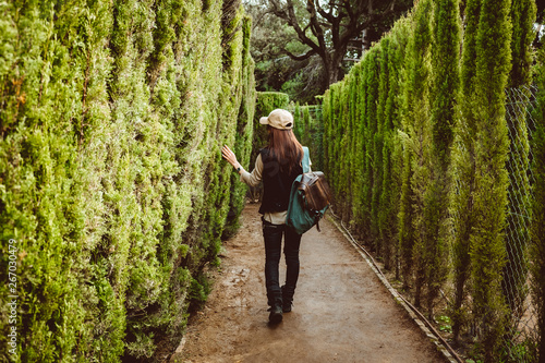Young woman walking in the park labyrinth photo
