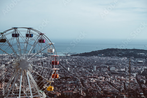 Colourful ferris wheel in the amusement park Tibidabo on background of blue sky
