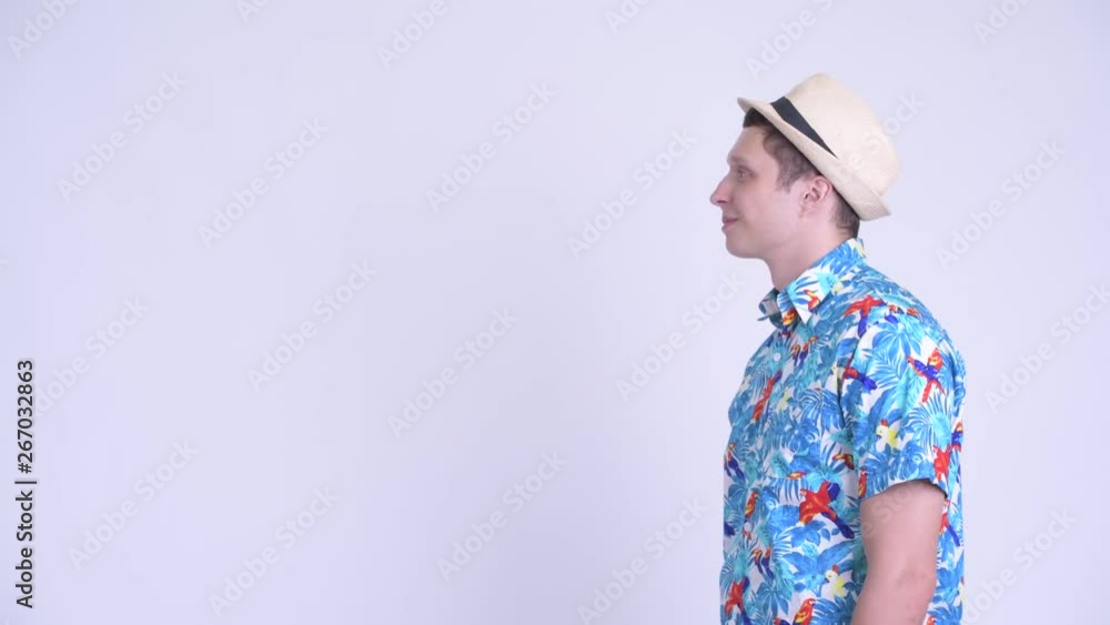 Profile view of happy young tourist man smiling