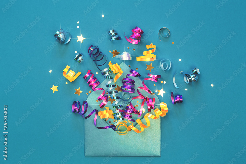 Birthday party explosion concept. Envelope with party streamers and confetti on yellow turquoise background. Invitation and greeting card, flat lay.