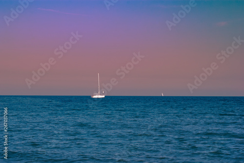 Yachts in the sea against the sunset sky