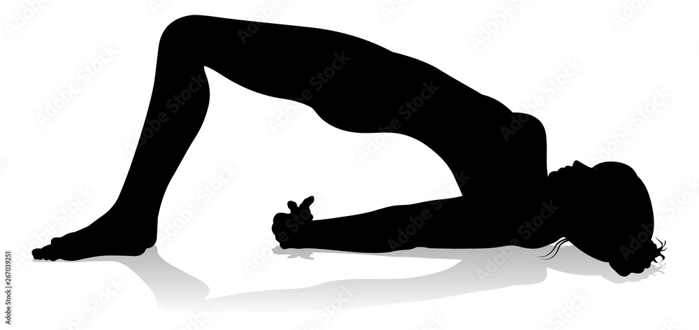 A silhouette of a woman in a yoga or pilates pose A silhouette of a woman in a yoga or pilates pose