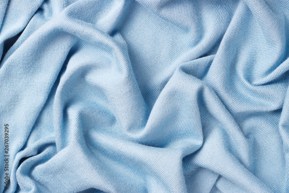 Obraz premium Background of crumpled blue cotton fabric, close-up, knitted texture