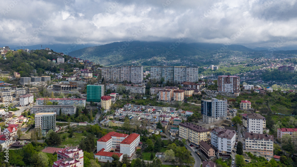 Aerial photography. Residential quarters of the city of Sochi with a bird's-eye view. Densely populated area of the city. City centre. The sky is grey the storm clouds. The view from the top.