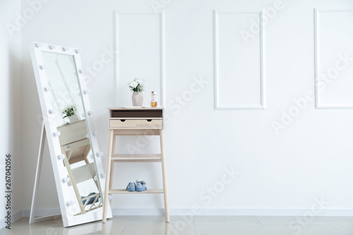 Floor mirror and table near...