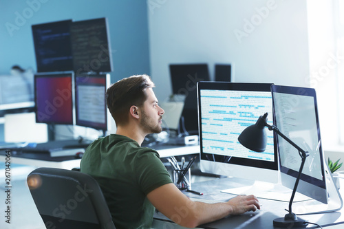 Male programmer working in office photo