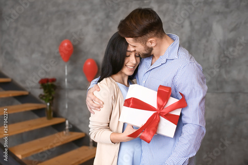Young couple with present a...