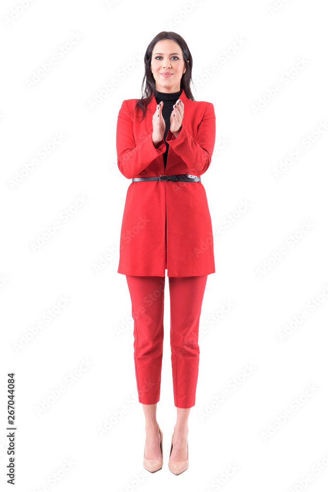 Young business woman in elegant red suit congratulating and applauding in standing ovations. Full body isolated on white background. Young business woman in elegant red suit congratulating and applauding in standing ovations. Full body isolated on white background.