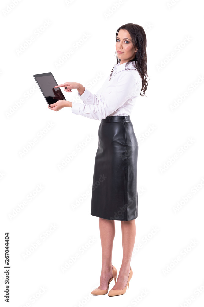 Young attractive business woman using digital tablet looking at camera. Full body isolated on white background. Young attractive business woman using digital tablet looking at camera. Full body isolated on white background.