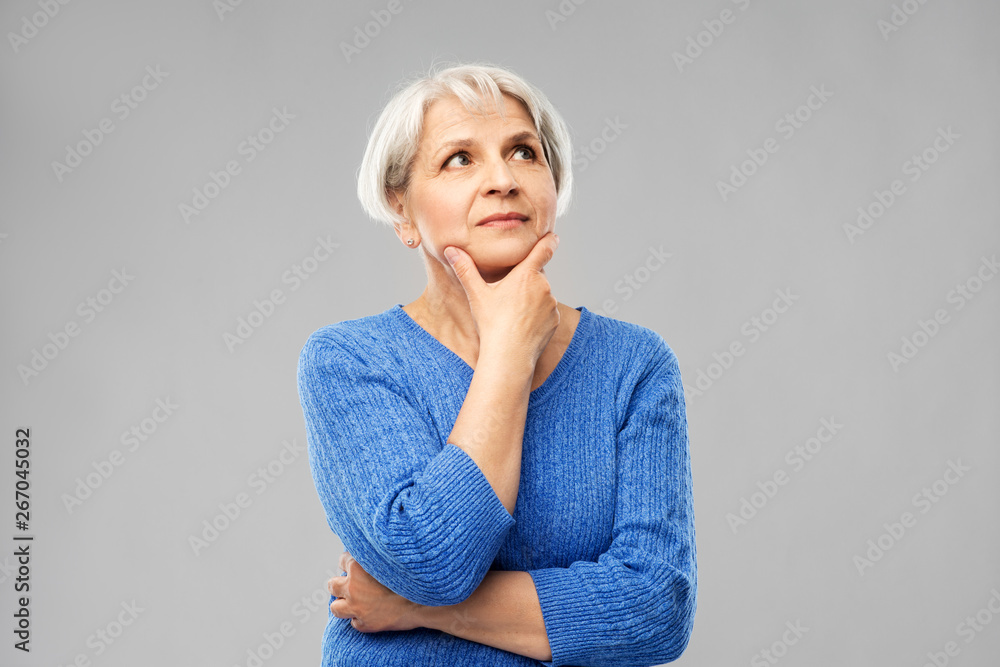 © Syda Productions - old people and decision making concept - portrait of senior woman in blue sweater thinking over grey background