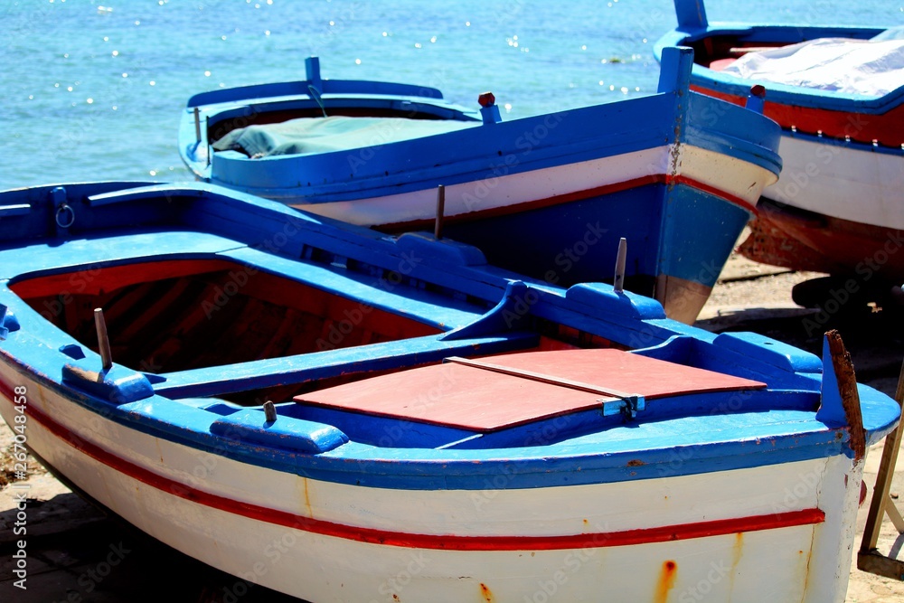 cute fishing boats in Sicily, Italy with blue sky and sea