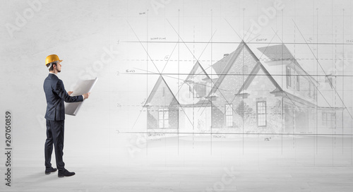 Architect standing and watching an imagined house plan
