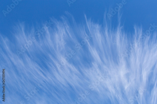 white cirrus clouds in a blue sky