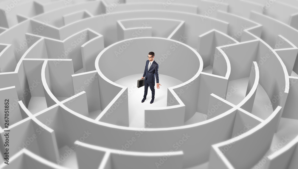 Young businessman standing in a middle of a 3d round maze
Young businessman standing in a middle of a 3d round maze