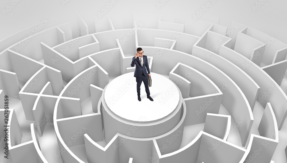 Businessman standing on the top a maze and looking through
Businessman standing on the top a maze and looking through