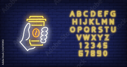 Hand holding disposable coffee cup neon sign