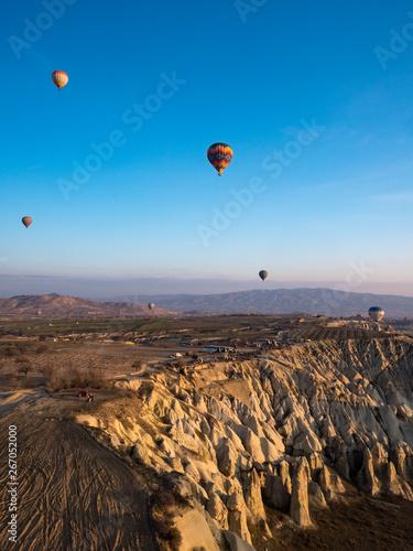 Amazing colorful hot air balloons flying over the valley at Cappadocia, Anatolia, Turkey. Volcanic mountains in Goreme national park. February, 2019