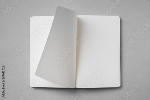 Tela white notebook with turn page on grey background